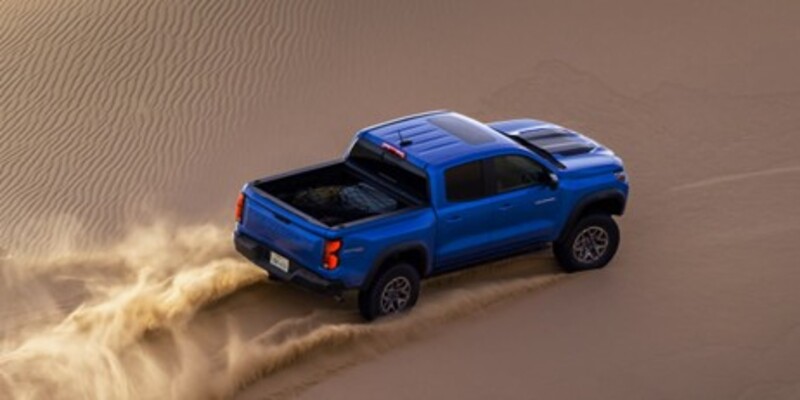 2026 Chevrolet Colorado driving through a desert landscape, highlighting its powerful performance and off-road capability.
