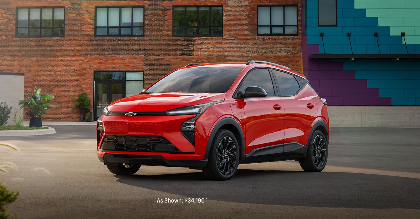 2027 Bolt EV parked in front of a brick building