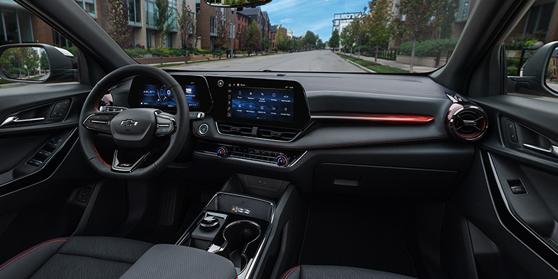 The image showcases the interior of a car with a dashboard and a large windshield. The dashboard features a large display screen.